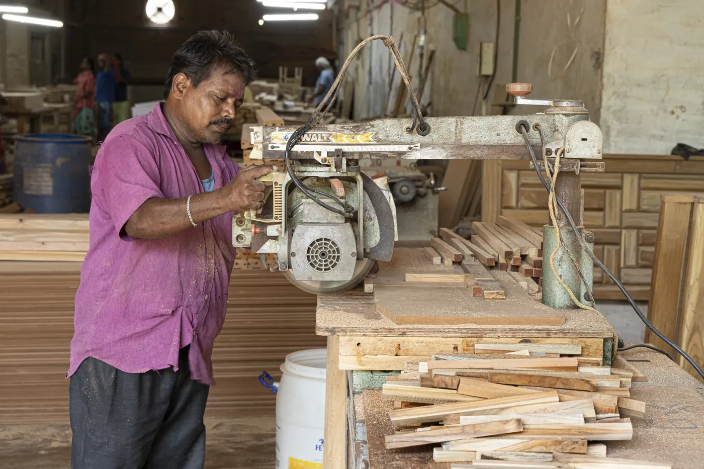 Craftsman cutting timber on a radial arm saw